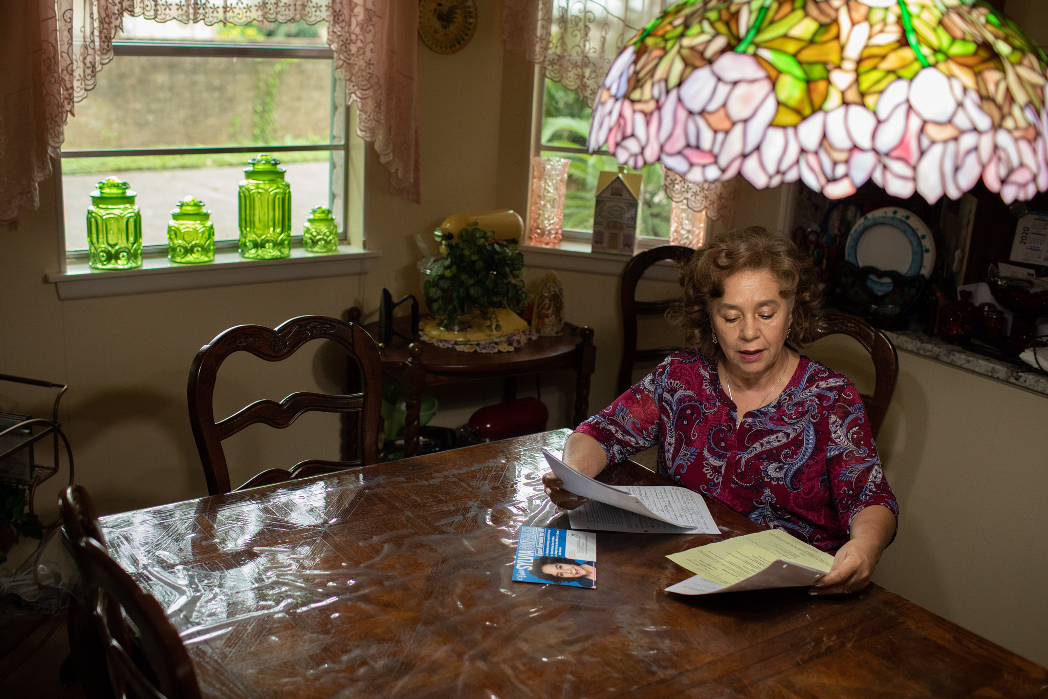 Woman sitting at a table reading documents