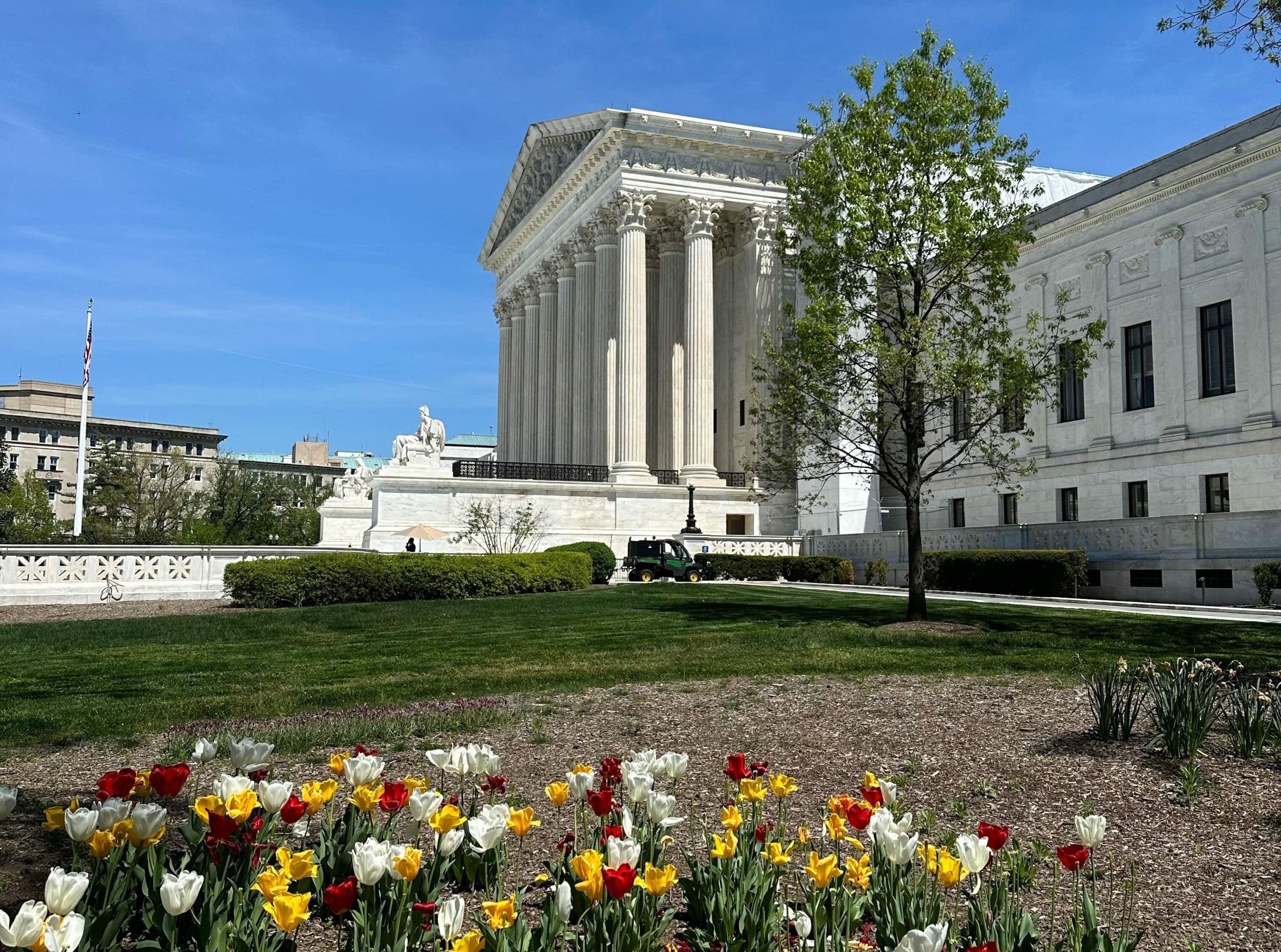 The Supreme Court building with tulips blooming in front