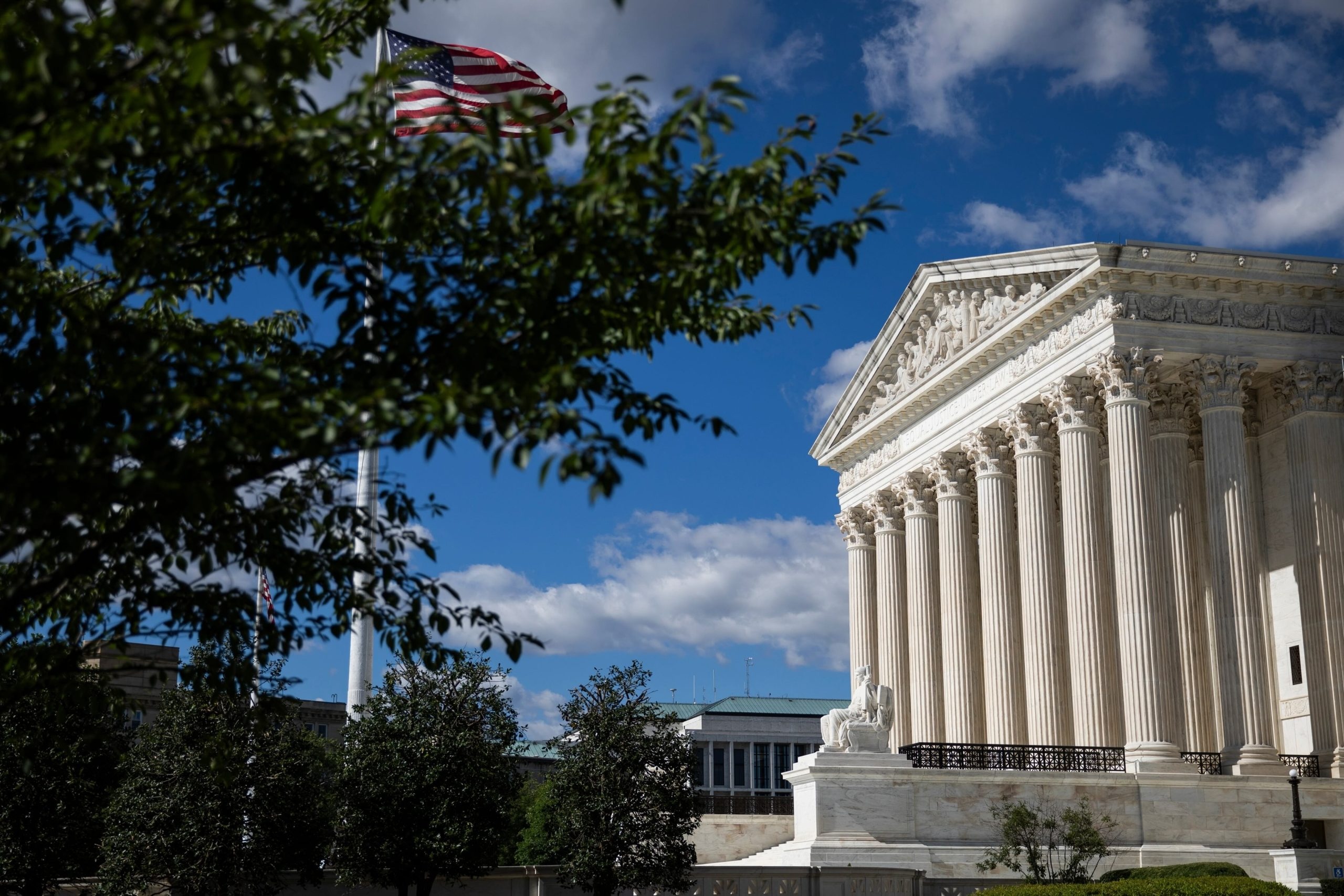 The Supreme Court with trees and a flag