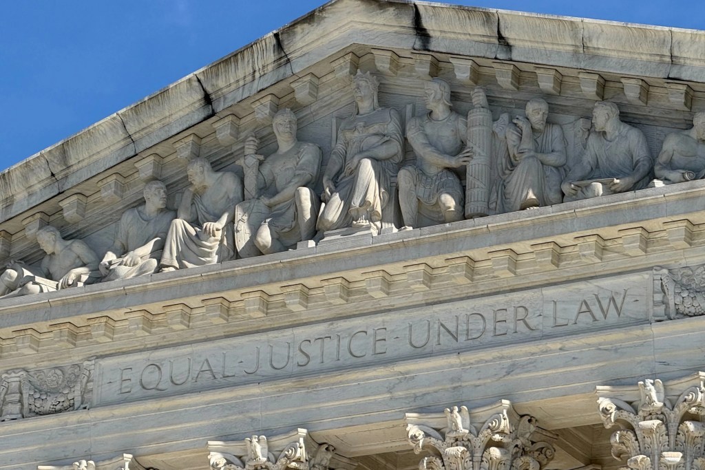 Carvings are shown at the top of the Supreme Court building