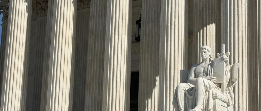 A statue is shown in front of the Supreme Court in Washington, D.C.