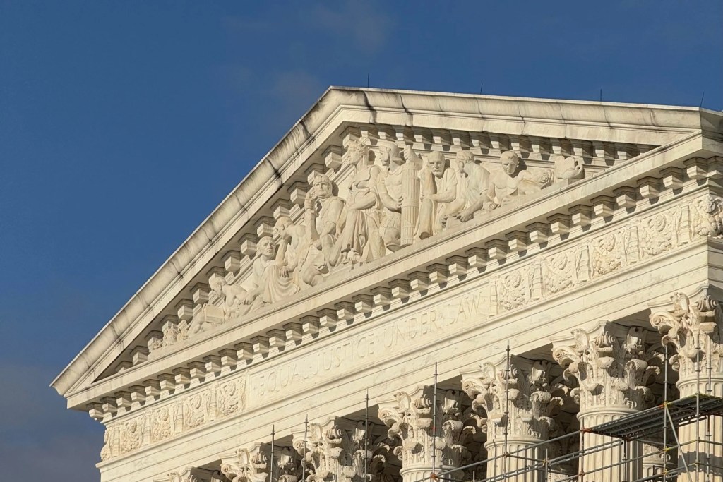 Carved details along top of Supreme Court building are pictured