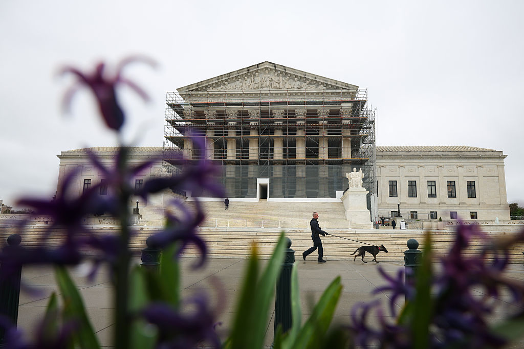 A member of the Capitol Police K-9 unit walks a dog in front of the U.S. Supreme Court is on April 07, 2025 in Washington, DC.