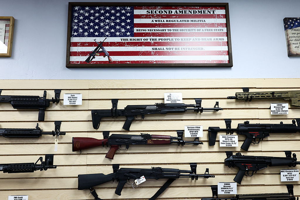 The Second Amendment (the right of the people to keep and bear arms) is spelled on a US flag above a display of firearms for sale in a gun store in Rio Rico, Santa Cruz County, Arizona on September 17, 2025.
